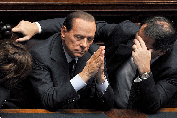 (FILES) – In this files picture taken on September 14, 2011 in Rome Italian Prime Minister Silvio Berlusconi (L) reacts during a session of the Italian parliament. An Italian court on October 19, 2013 ordered a two-year ban from parliament and elections for scandal-tainted former prime minister Silvio Berlusconi as part of a tax fraud case, Italian media reported. Berlusconi can appeal the ruling and the ban would in any case have to be approved by the Senate, where Berlusconi has a parliamentary seat. AFP PHOTO / ALBERTO PIZZOLI