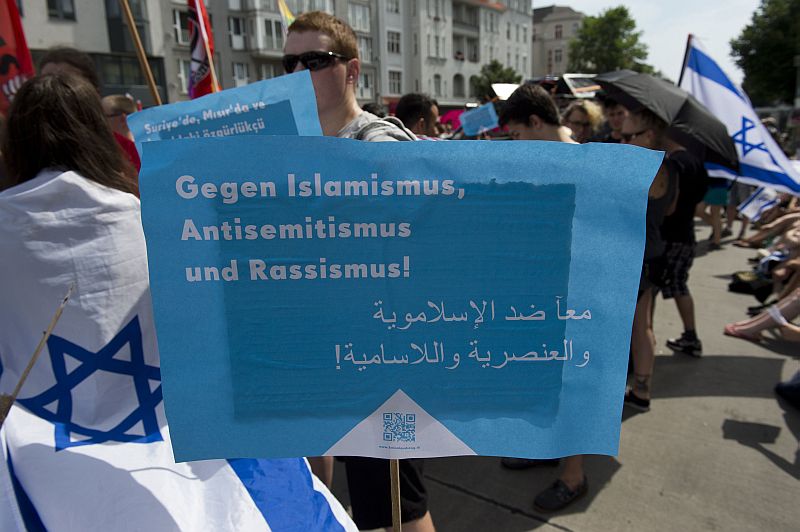 Demonstrators protesting against the Quds Day rally display a placard reading “Against Islamism, Antisemitism and Racism” in Berlin, Germany on August 3, 2013. Quds Day, initiated by the Iranian government in 1979, takes place every year on the last friday of Ramadan, to express solidarity with the Palestinian people and to oppose Israel’s control of Jerusalem. AFP PHOTO / JOHN MACDOUGALL