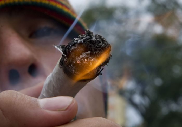 A youngster smokes marijuana during a march for the legalization of cannabis in Medellin, Antioquia department, Colombia on May 5, 2012, as part of the 2012 Global Marijuana March which is being held in hundreds of cities worldwide. AFP PHOTO/Raul ARBOLEDA