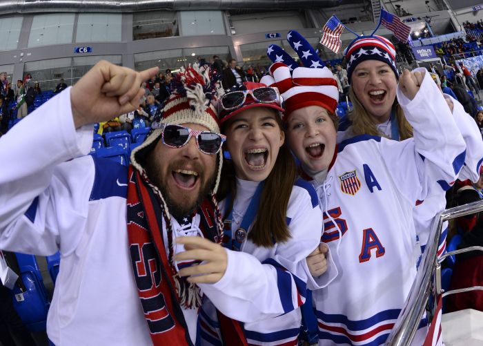TOPSHOTS
USA Ice Hockey supporters cheer their team prior to the Women’s Ice Hockey Group A match Canada vs USA at the Shayba Arena during the Sochi Winter Olympics on February 12, 2014. AFP PHOTO / JONATHAN NACKSTRAND