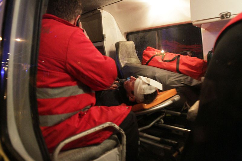 A wounded Ukrainian pro-European opposition activist is in a ambulance after clashing with the riot police near a district court in Kiev on January 11, 2014. The activists were protesting against a court decision regarding several activists accused of terrorism. AFP PHOTO / ANATOLII BOIKO