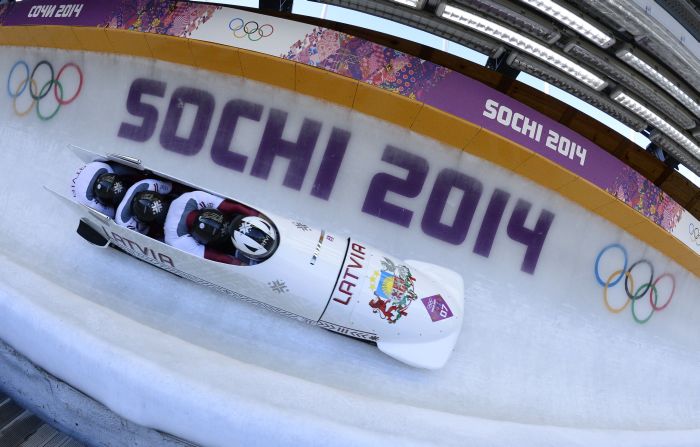 Silver Medallist, Latvia-1 four-man bobsleigh, pilot Oskars Melbardis, pushman Daumants Dreiskens, pushman Arvis Vilkaste and brakeman Janis Strenga compete in the Bobsleigh Four-man Heat 4 and final run at the Sanki Sliding Center during the Sochi Winter Olympics on February 23, 2014. AFP PHOTO / LIONEL BONAVENTURE
