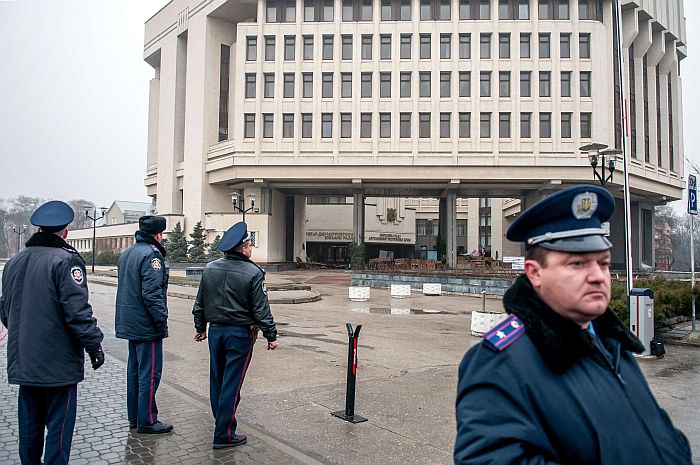 Police officers guard the parliament building in Simferopol on February 27, 2014. Pro-Russian armed men on February 27 seized the parliament and government buildings in the Ukrainian region of Crimea and raised Russian flags above them, the Interfax-Ukraine news agency reported. Dozens of men in full combat dress but without any markings of affiliation marched into the buildings earlier in the morning and removed the guards without any fight, the agency quoted sources in parliament as saying. AFP PHOTO/ OLEKSANDR POLEHENKO