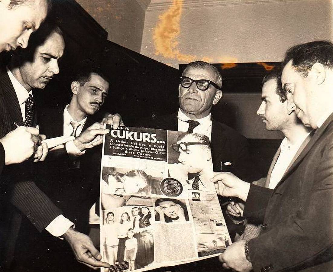 H. Cukurs kopā ar advokātu, policijas prefektu un žurnālistiem. Riodežaneiro. 20. gs. 50. gadu beigas – 60. gadu sākums.