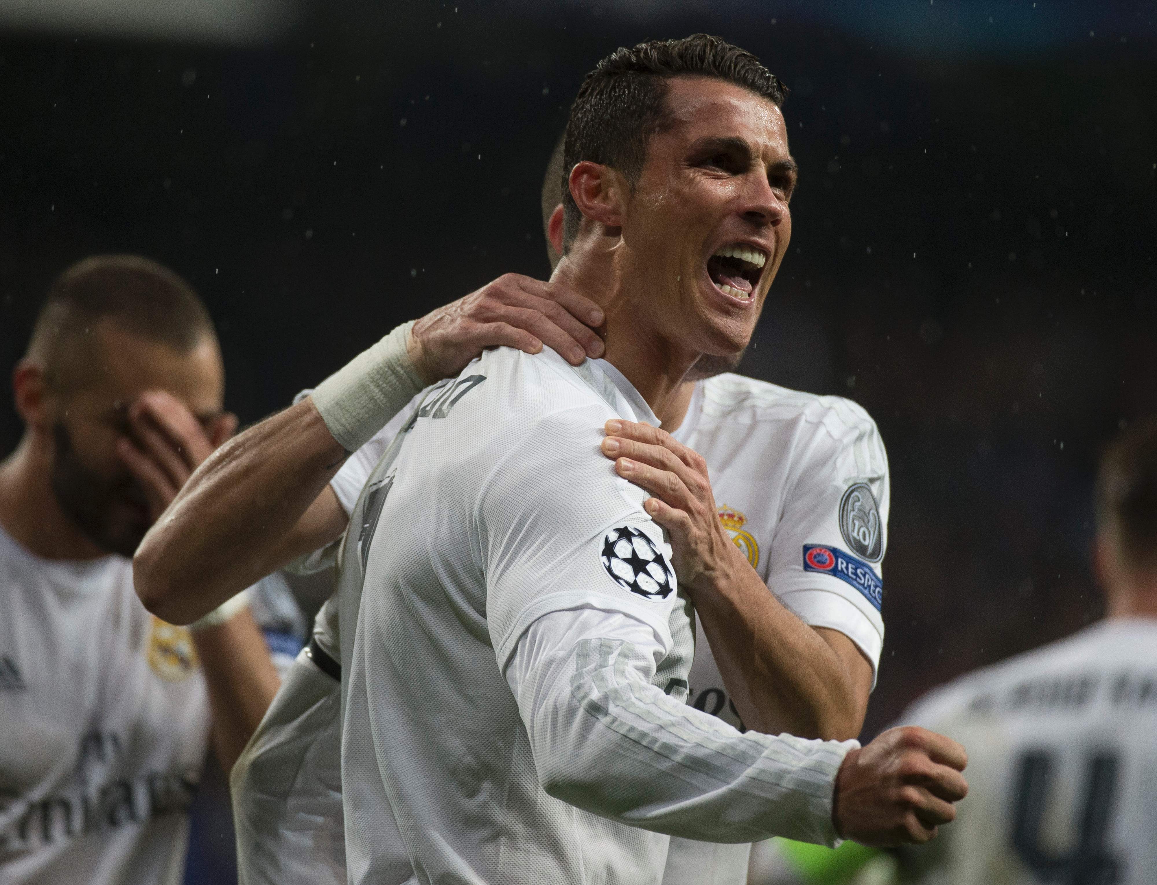 Real Madrid’s Portuguese forward Cristiano Ronaldo celebrates after scoring during the Champions League quarter-final second leg football match Real Madrid vs Wolfsburg at the Santiago Bernabeu stadium in Madrid on April 12, 2016. / AFP PHOTO / CURTO DE LA TORRE