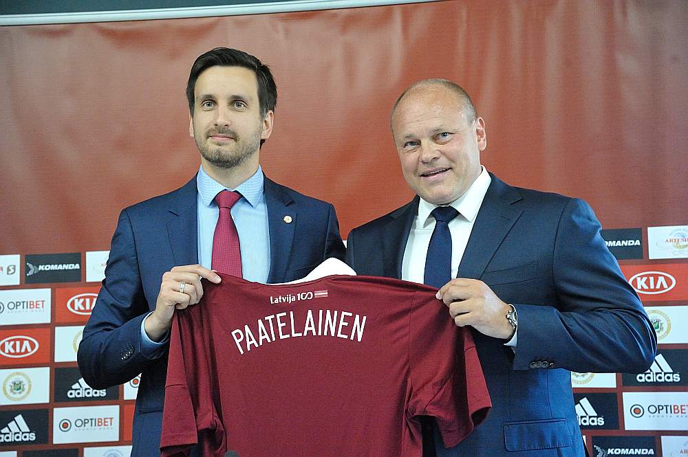 Latvijas Futbola federācijas izpilddirektors Edgars Pukinsks (no kreisās) Miksu Pātelainenu izlasē uzņēma, pasniedzot viņam tās formas kreklu.