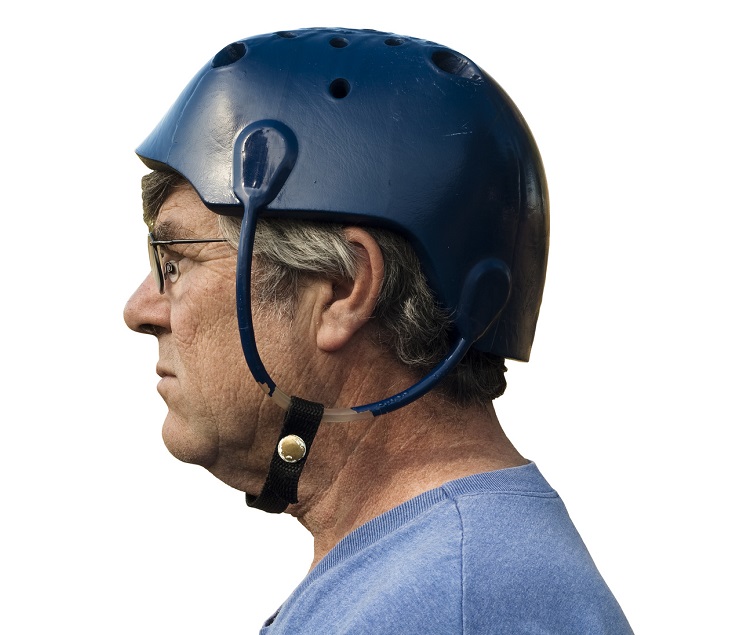 man wearing a seizure helmet for protection with clipping path included