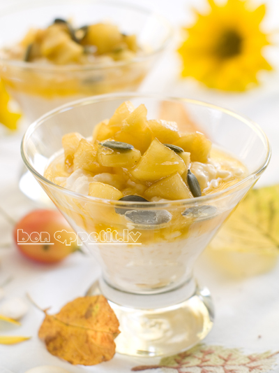 Creamed rice pudding with apple and pumpkin seed, selective focus