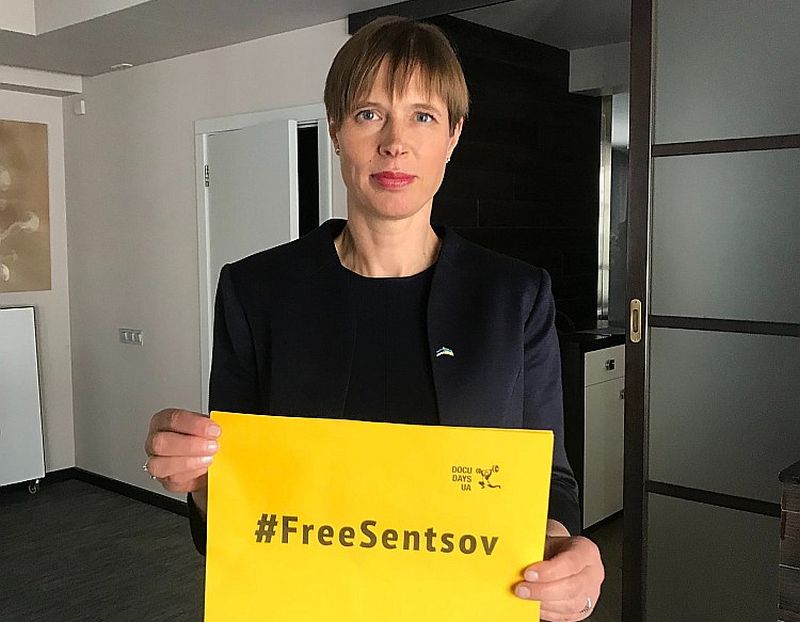 Igaunijas prezidente Kersti Kaljulaida tur rokās plakātu ar aicinājumu atbrīvot Krievijas ieslodzīto Ukrainas režisoru Oļegu Sencovu.