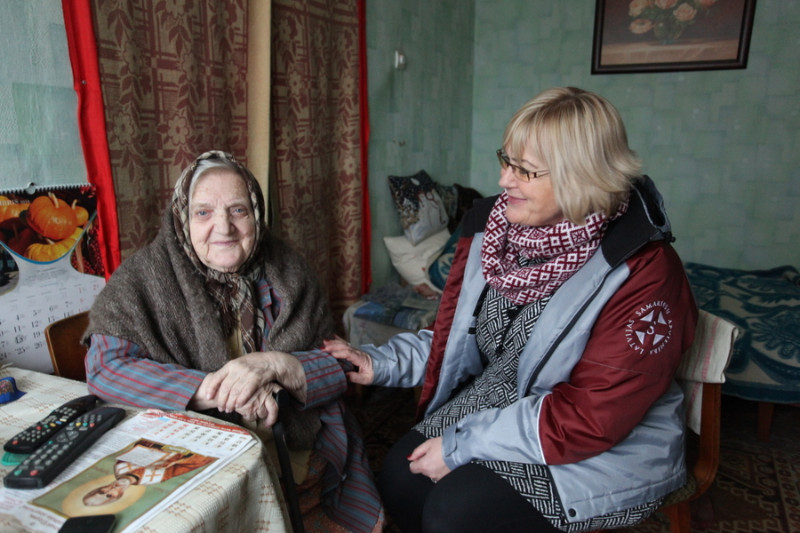 Aleksandra Seļezeņeva (no kreisās) pēc vīra nāves dzīvoklī palikusi viena. Palīdz kaimiņi un samarieši, tikai pietrūkstot sarunas biedru. Attēlā: Ciemos pie Aleksandras atbraukusi Aija Purmale, Latvijas Samariešu apvienības Zemgales nodaļas vadītāja.